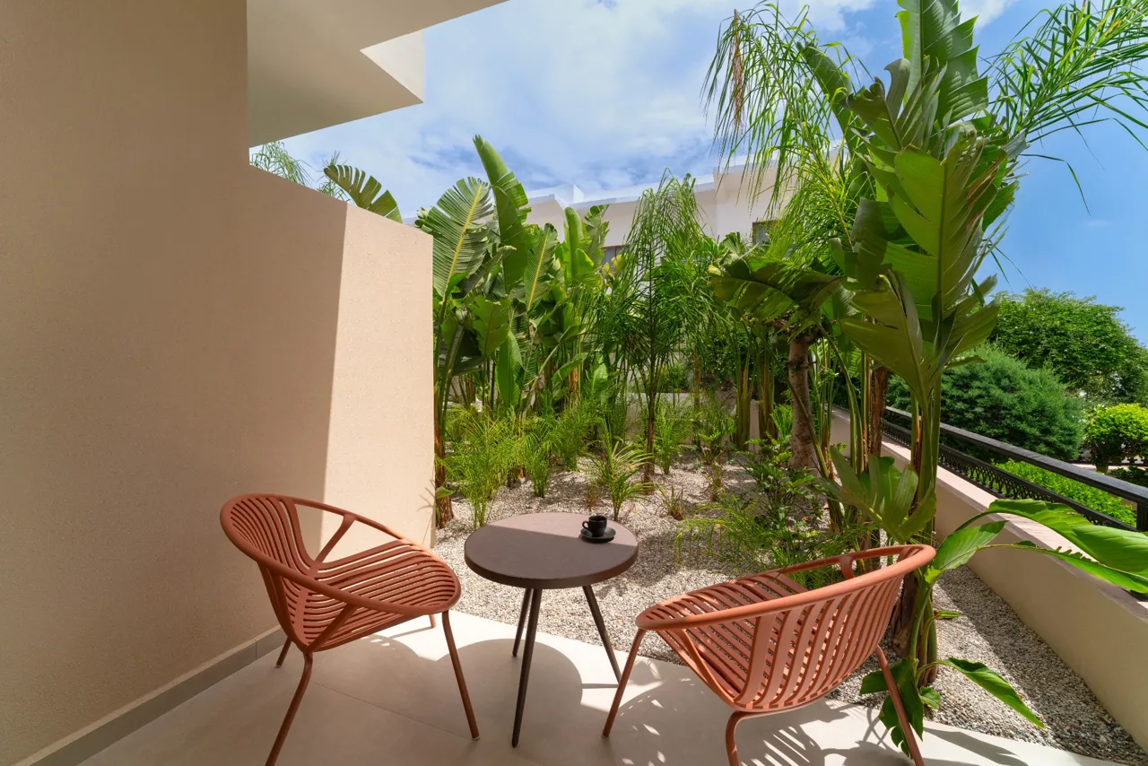 Sunlit private terrace with palms and seating